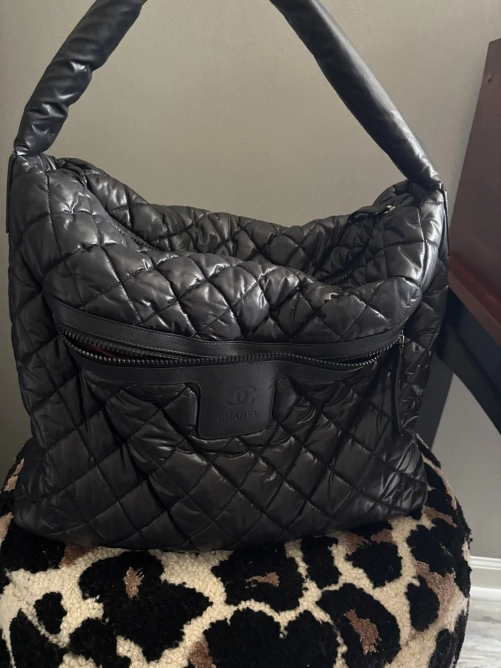 CHANEL Black Quilted Puffer Bag with Embossed CC Patch